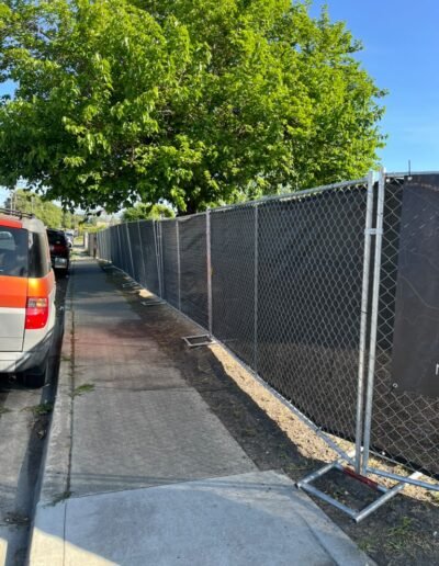Long temporary chain link fence along sidewalk